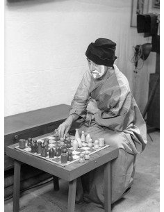 Man Ray (chess board)   Man Ray disguised and made up, sitting in f...