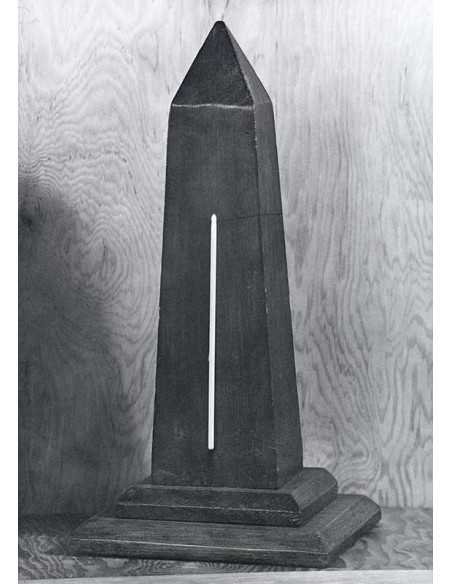 Proverb On a wooden obelisk model is glued, like a thermometer, a k...