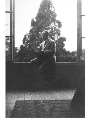 Henri Matisse   sitting by a window, reading a magazine  Henri Matisse