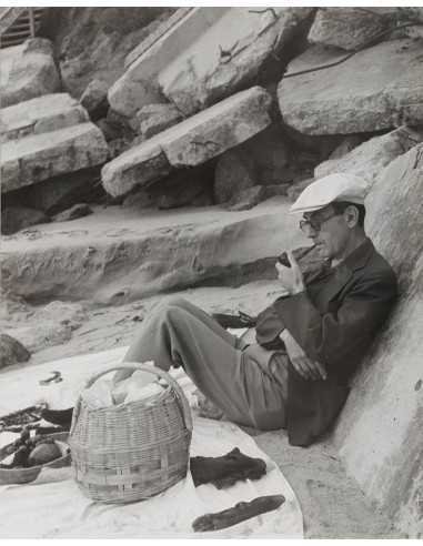 Man at the beach annotated Man at the beach sitting against rock dr...