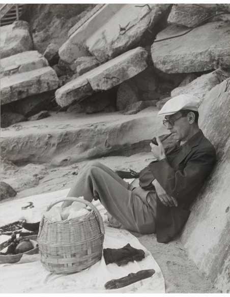 Man at the beach annotated Man at the beach sitting against rock dr...